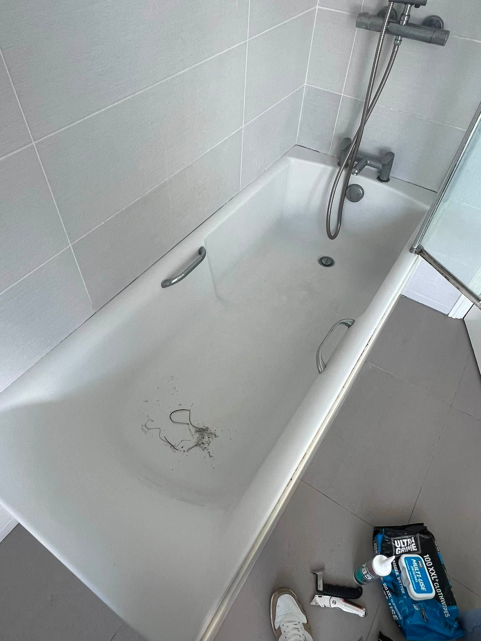 Bath edge showing an existing silicone seal before specialist work